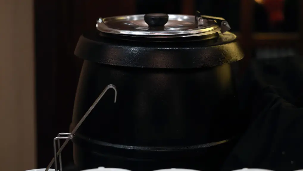 image of Stainless steel hinged lid and a smart black finish soup kettle.