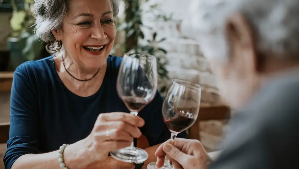 Image of Senior friends cheers with wine glasses