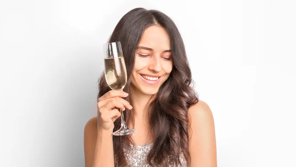  woman with champagne in hand on white background