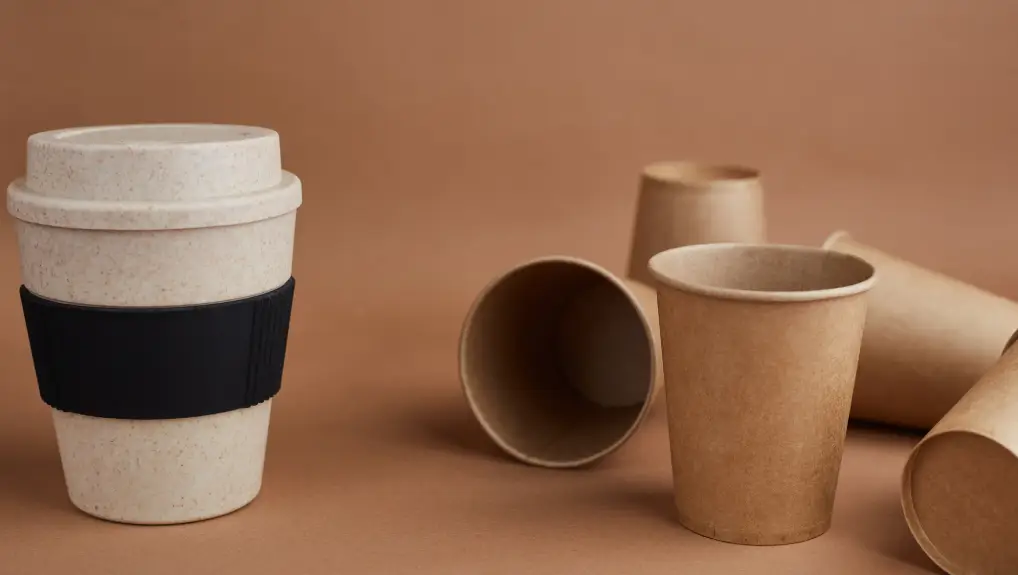 image of One reusable bamboo cup against a lot of disposable paper cups