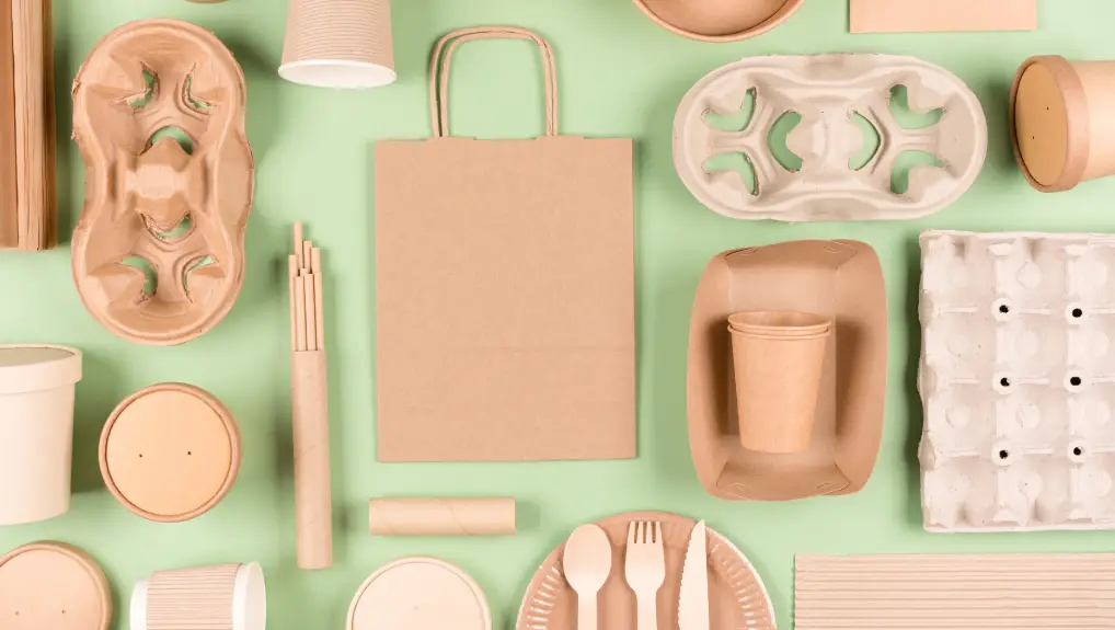 image of Eco tableware, paper utensils and wooden bamboo cutlery set over light green background