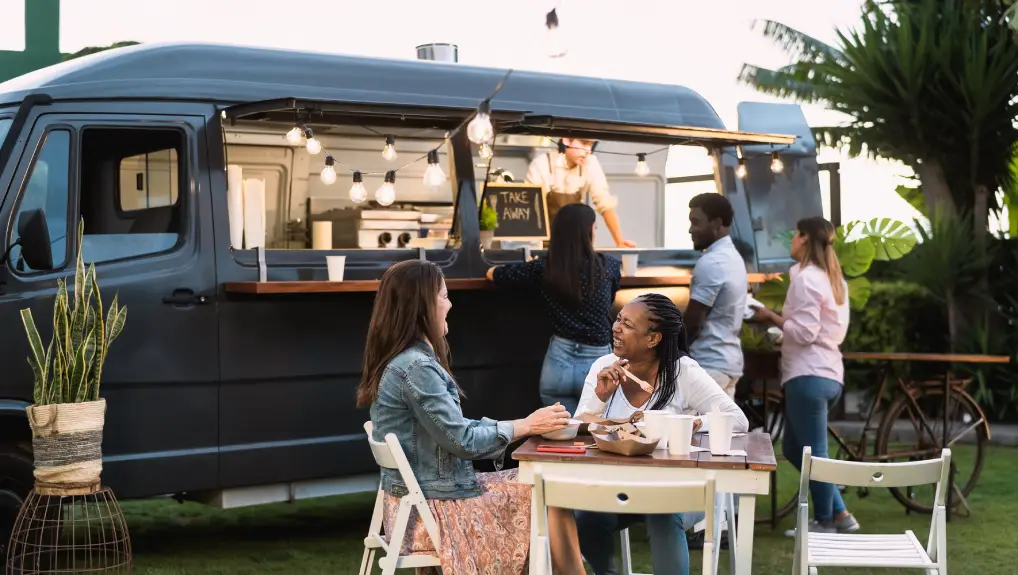 Image of people having fun drinking in a street food and drink truck