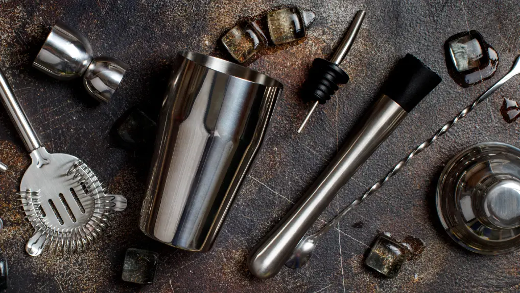 Image of Bartender tools for cocktail making on a dark table top view