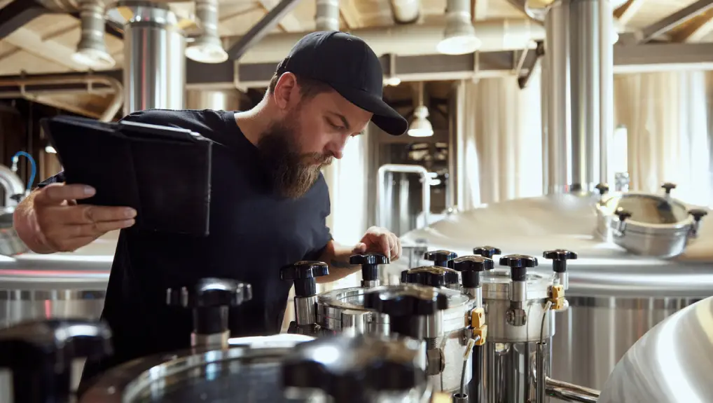 Image of bartender checking bar equipment maintenance tips for longevity of assets