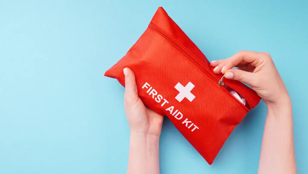 Image of Close-up of a woman's hands holding a fully-equipped first aid kit, ready for providing immediate medical assistance in case of emergencies
