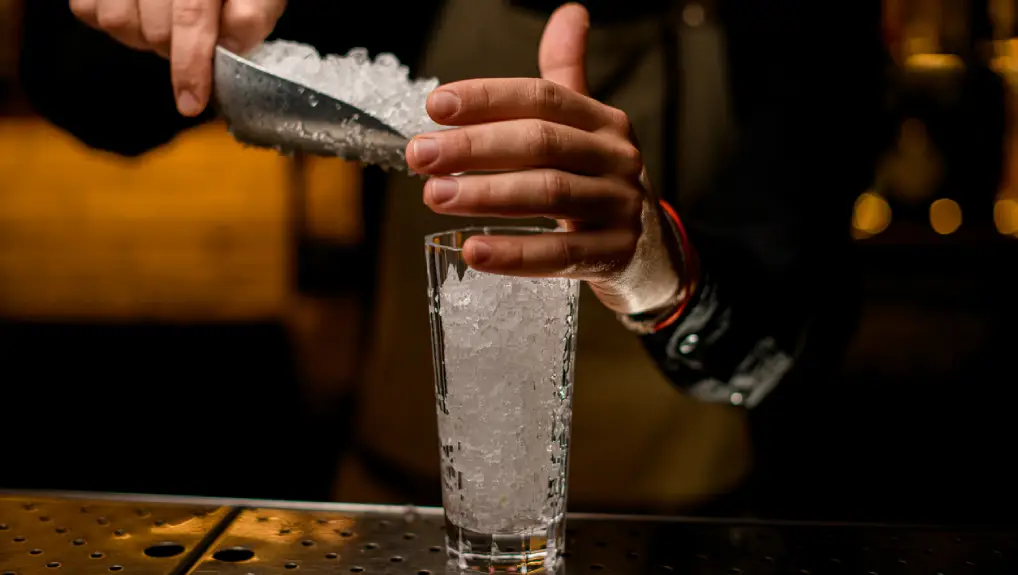 Close up image of bartender using the best ice tools for crafting premium cocktails