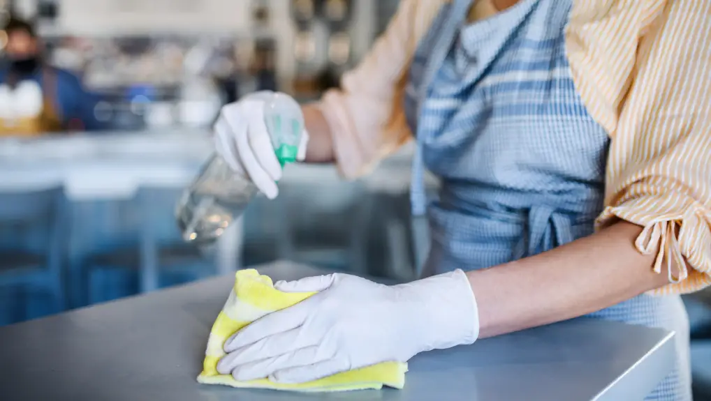 Image of woman cleaning bar