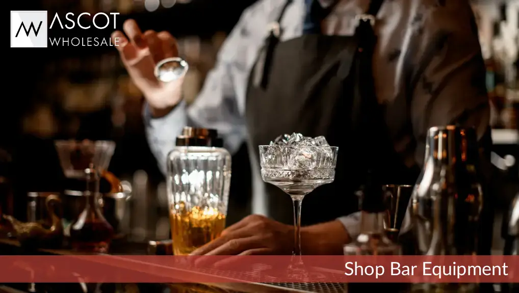 Close up image of a bartender using essential bar tools to make a cocktail