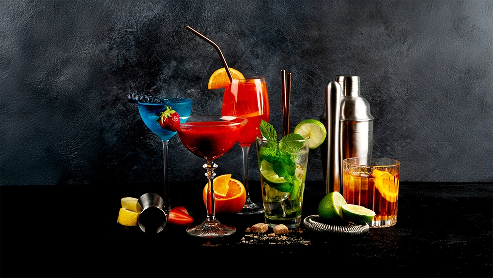 Summer cocktail in glasses on a dark background. Bar delicious drinks.