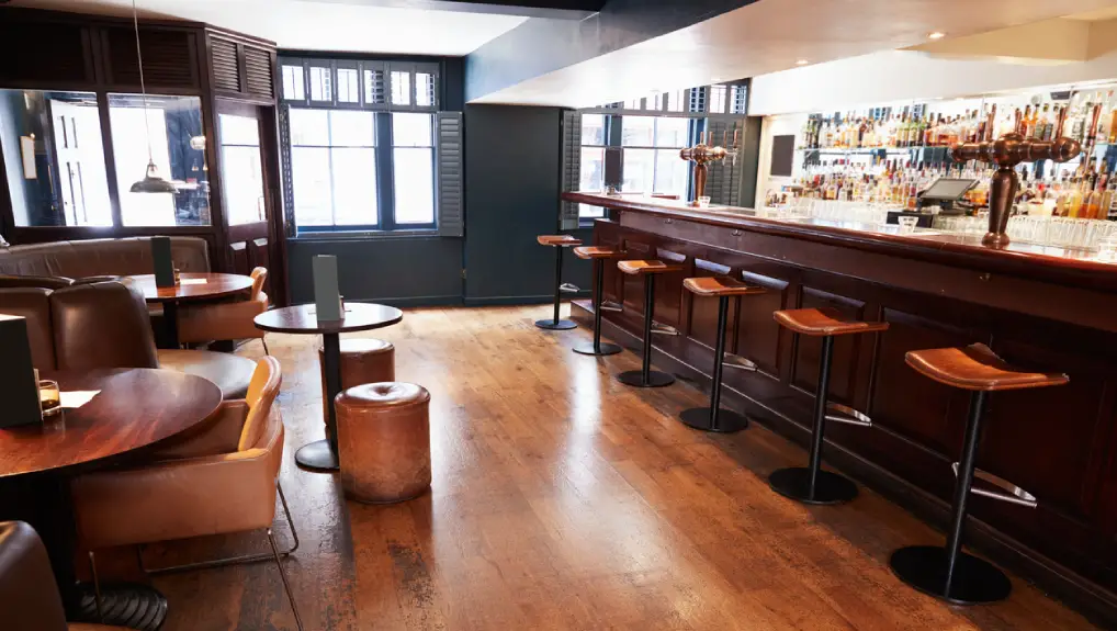Image of a space efficient commercial pub, the bar is empty and show space.