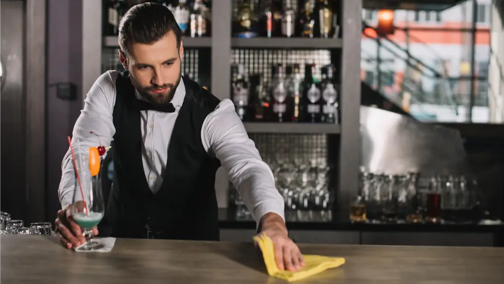 image of bartender maintaining the bars clean standard