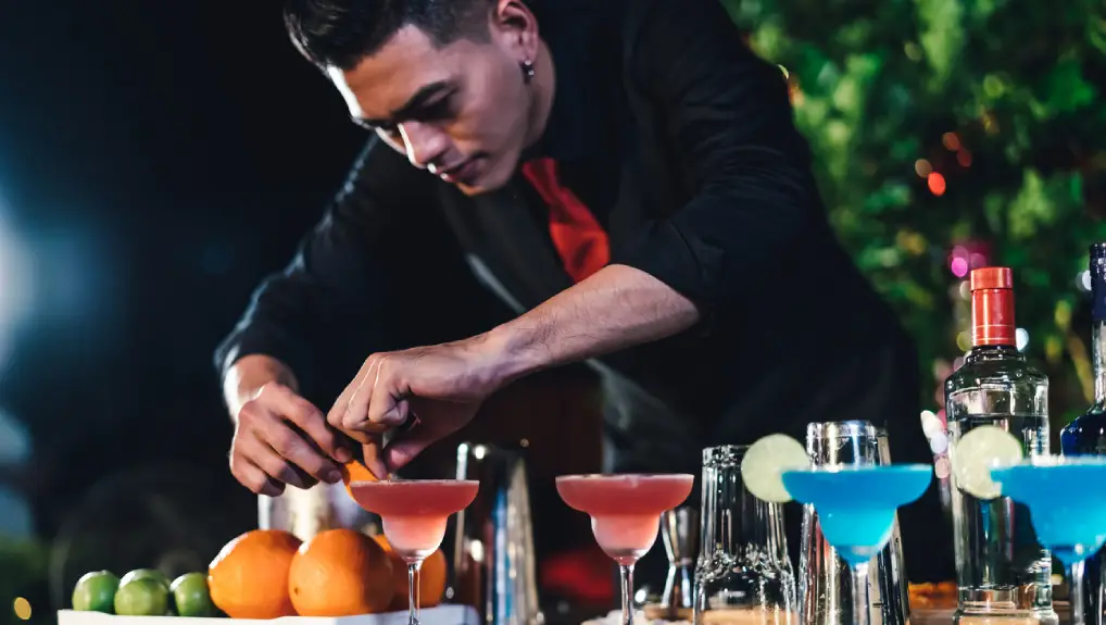 an image of a bartender creating and concocting various drinks and cocktails