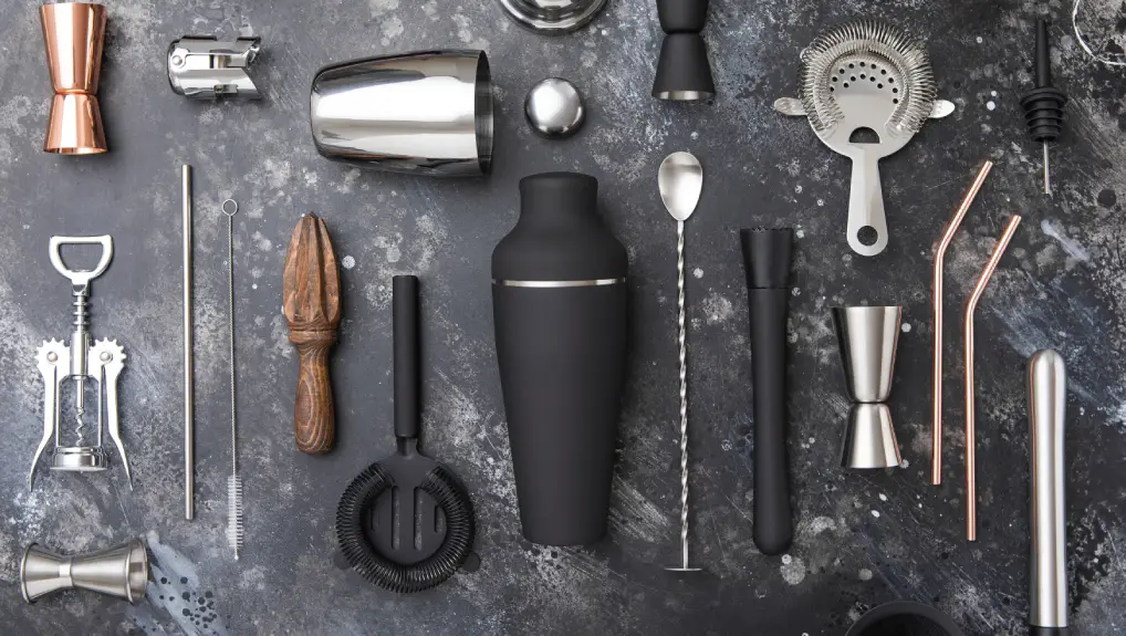 image of birds eye view layout of bar tools that were used in the rise of mixology, all different finishes and colours