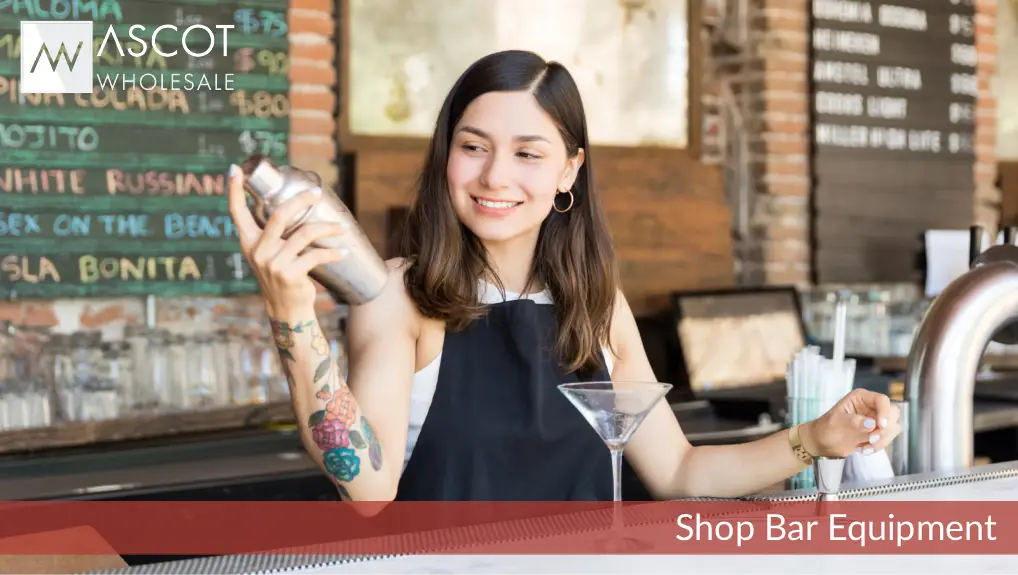 Image of female aspiring mixologist using an affordable starter kit including cocktail in shaker on abar counter.