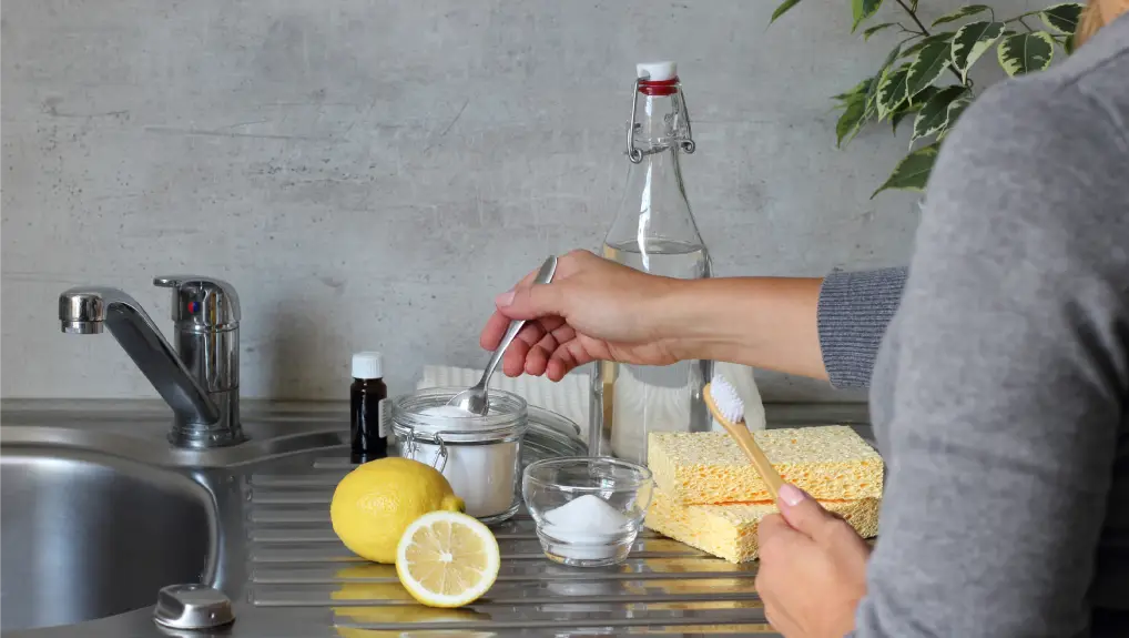 image of lemon and carbonate soda being used as a sustainable and eco-friendly cleaning method