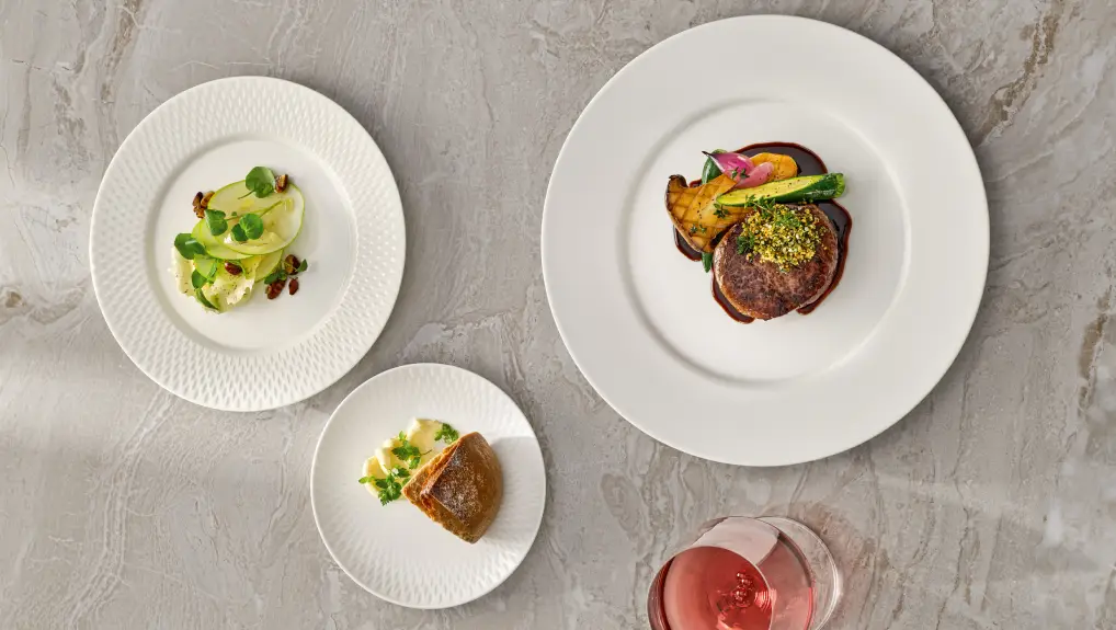 A lifestyle image of white china plates. restaurant tableware guide