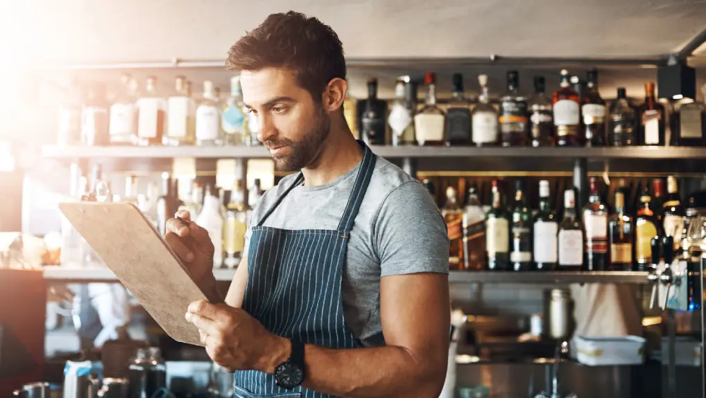 image of man ensuring procedures are in place for the bar setup