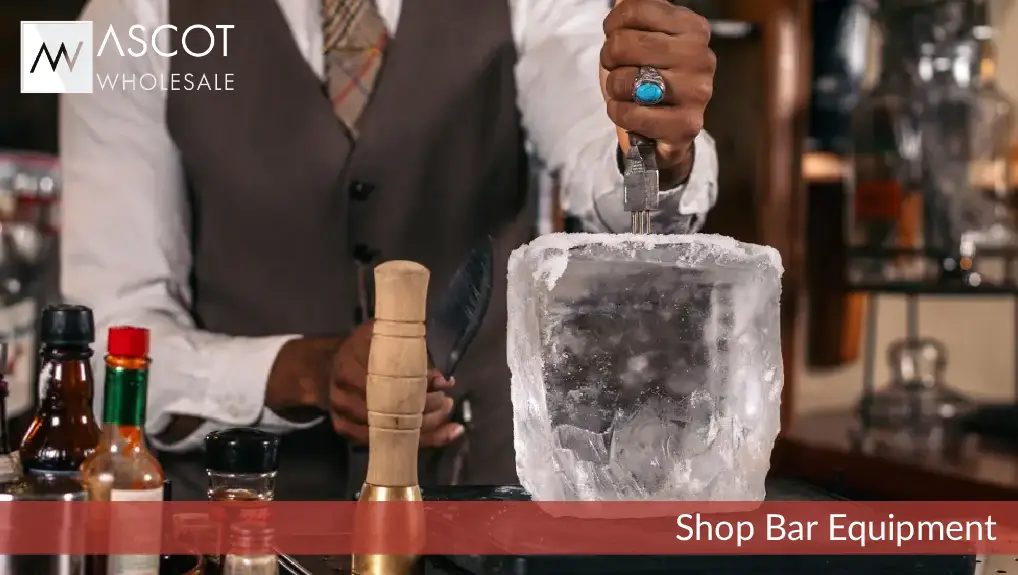 Image of a bartender breaking an ice block. with well serviced ice tools.
