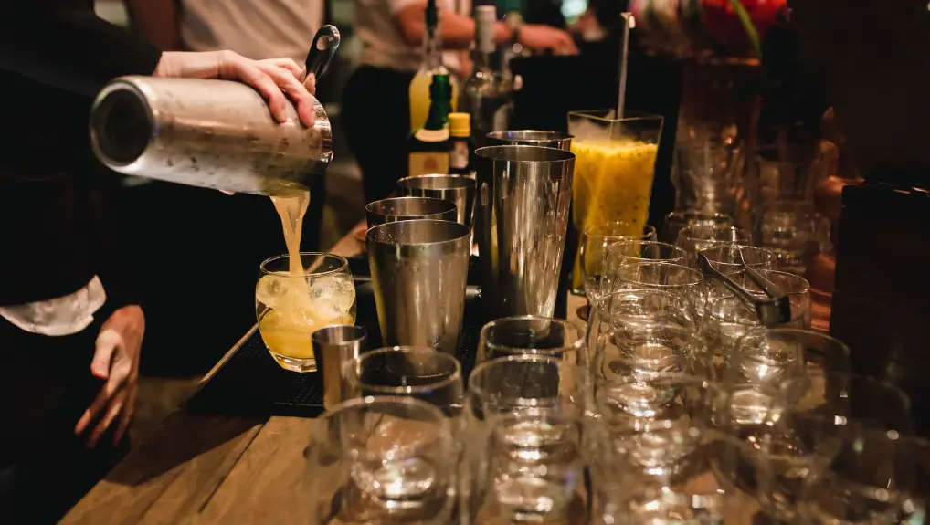 Image of Woman Bartender Serving a brazilian caipirinha in a wedding party