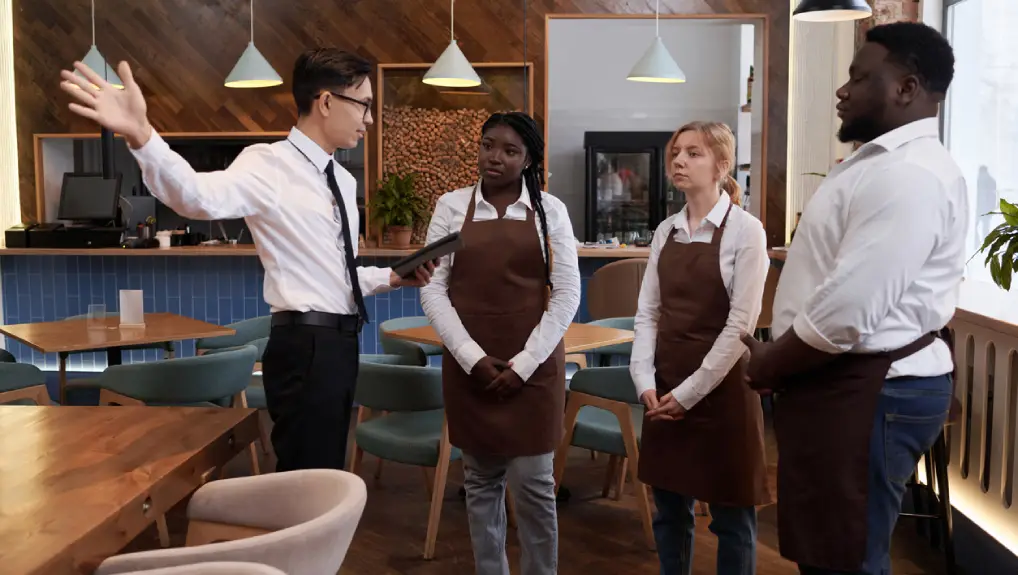 image of manager and waiting staff discussing training and staffing