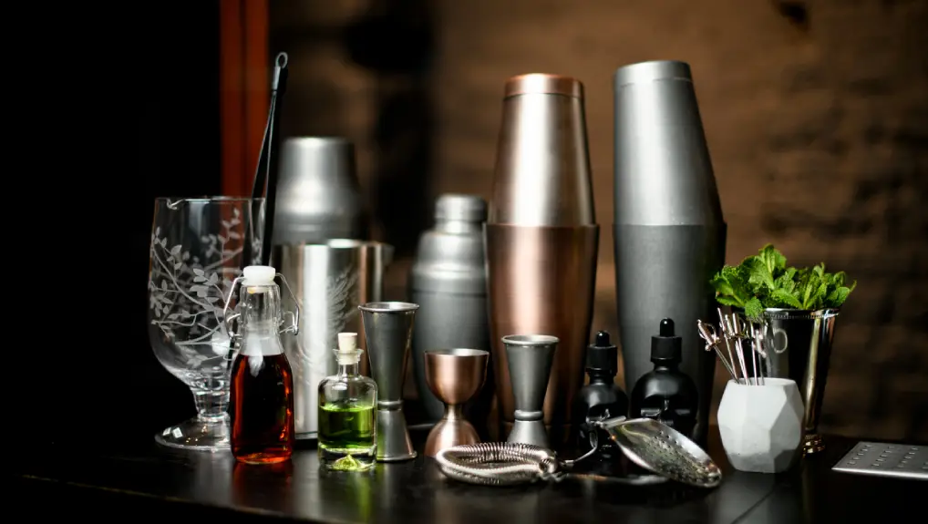 image of view composition with different bar equipment and steel tools which stand on bar counter.