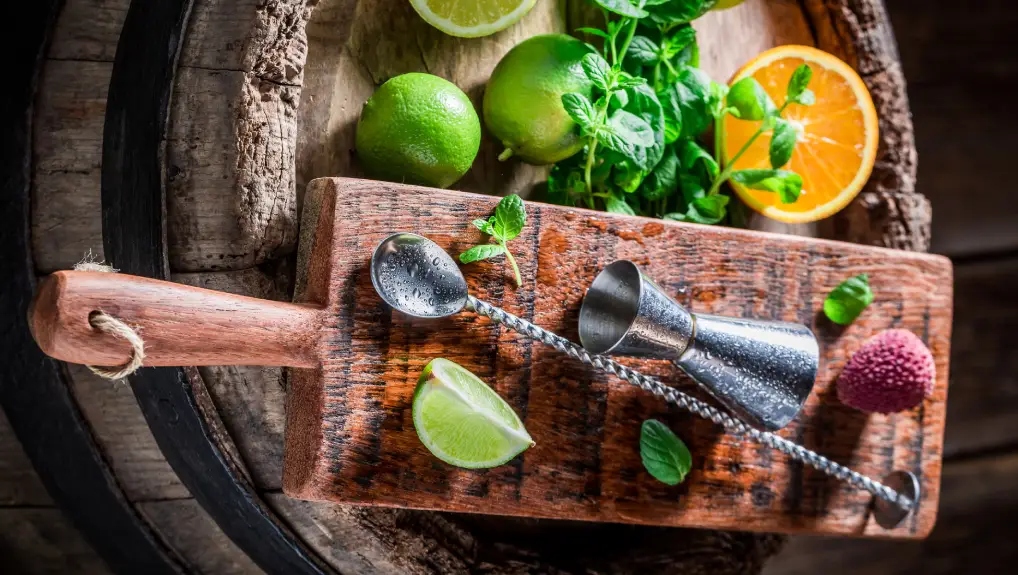 Image of Bartender spoon and accessories with citrus, herbs and mint