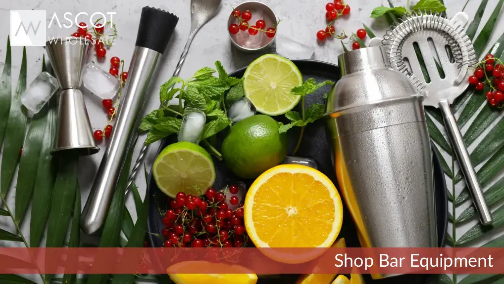 image of a cobbler shaker with a selection of other bar tools and garnish