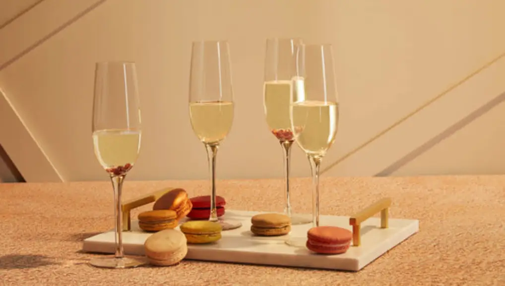 Image of champagne glasses on a platter of macaroons- Glassware Brand 