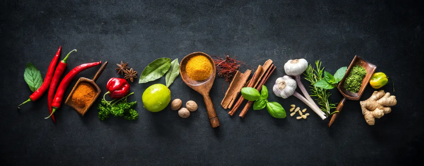 image of Various herbs and spices on dark background