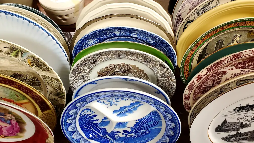 racks of old fashioned plates vs new restaurant tableware