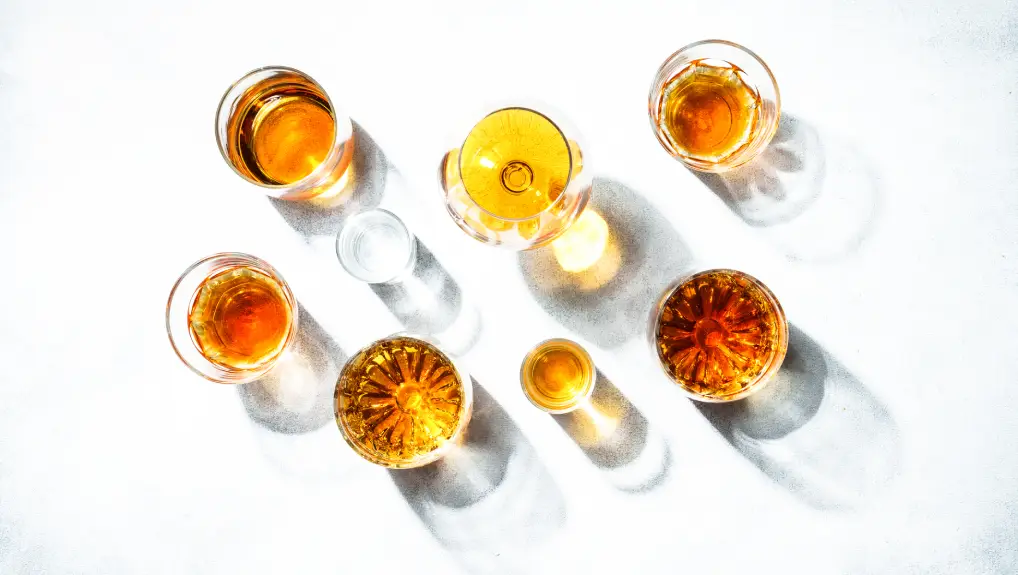 Strong alcohol drink. Cognac, whisky, rum, tequila at white background. Top view.
 wholesale glassware buying guide