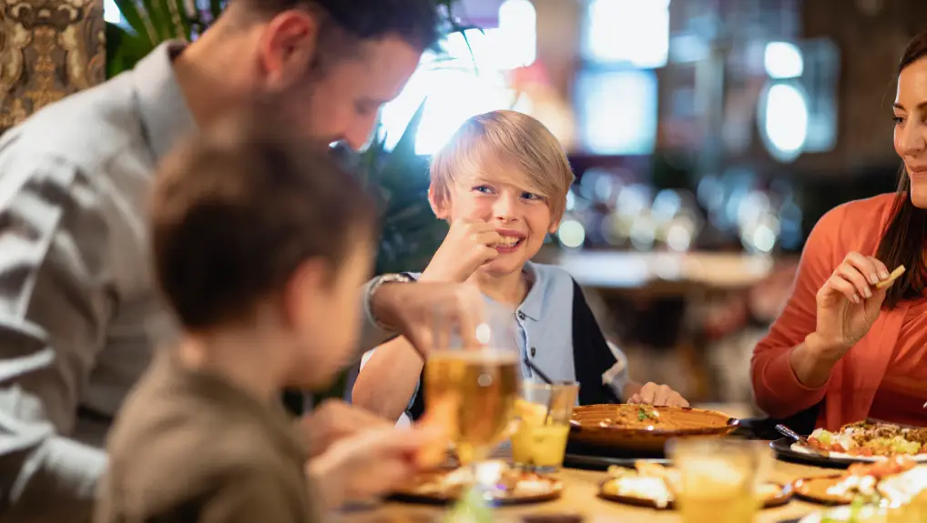 Image of A family having a meal together in a restaurant.