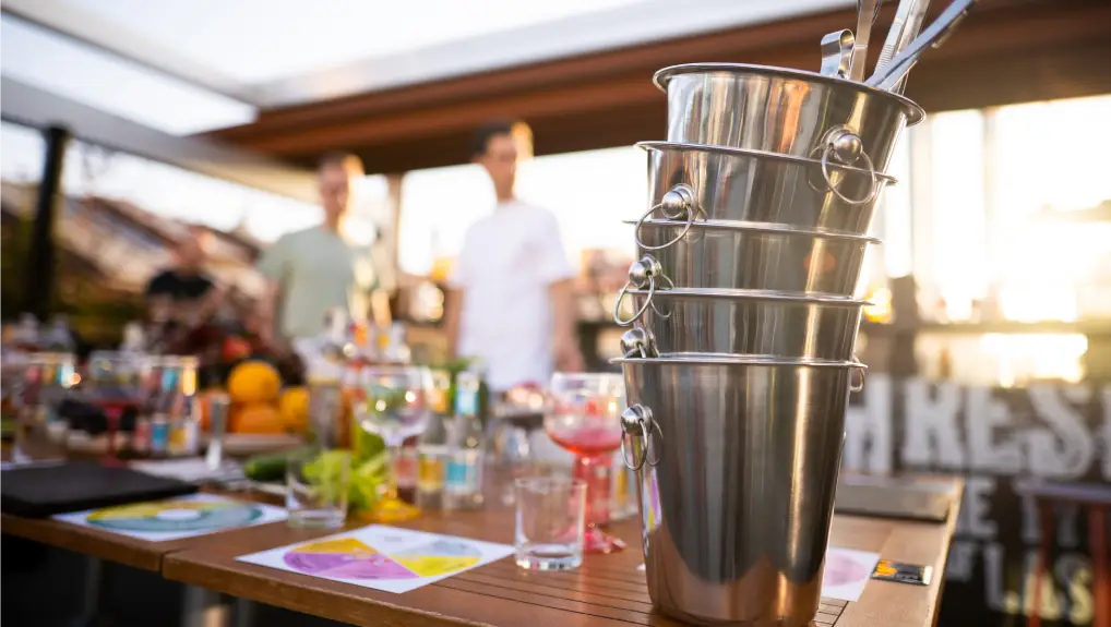 image of metal ice bucket on bar counter with ice scoop tool.
outdoor bar accessories summer 2025