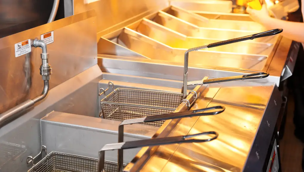 Image of a Deep fryer with boiling oil on restaurant kitchen