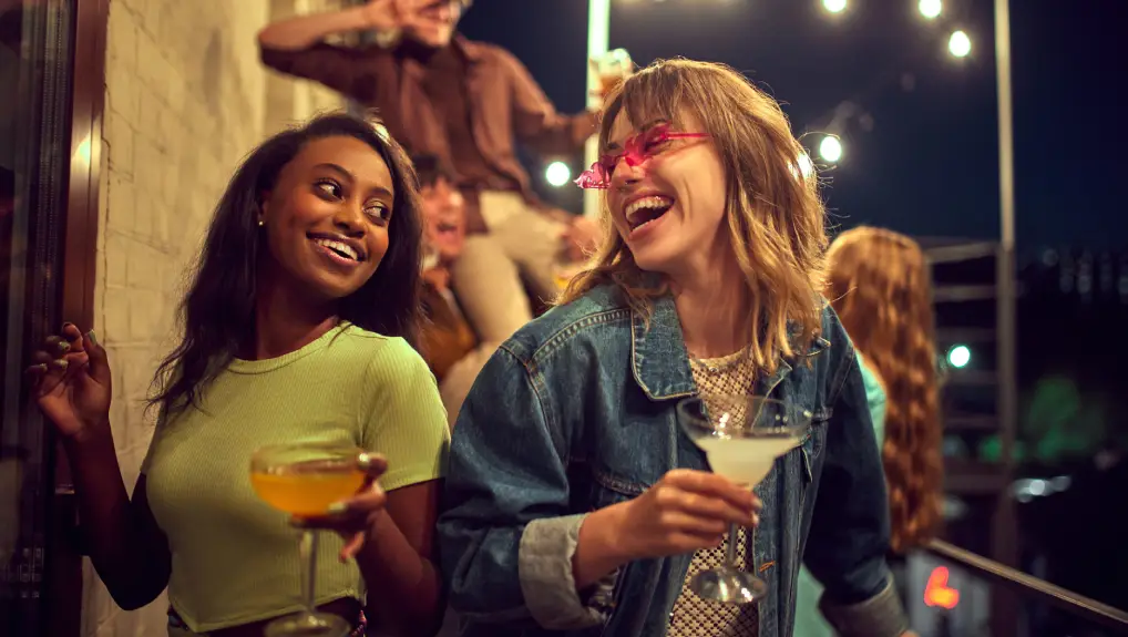 image of friends meeting at garden bar, having fun and drinking cocktails
