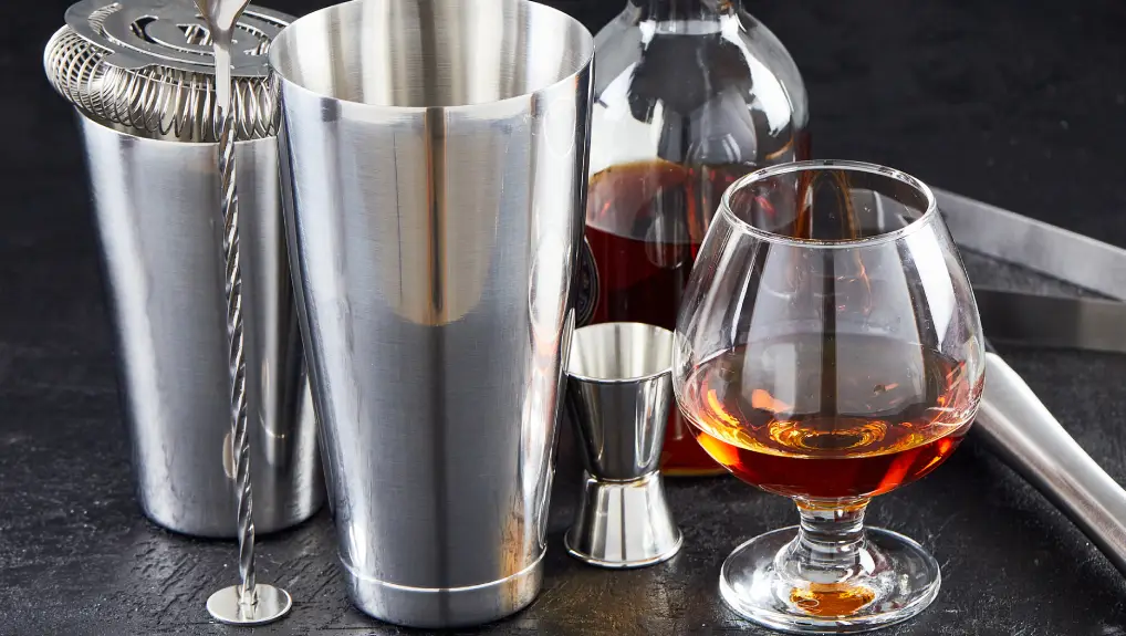 image of Brass bar tools and accessories for making cocktails. A set of accessories for the bartender's work in close-up.