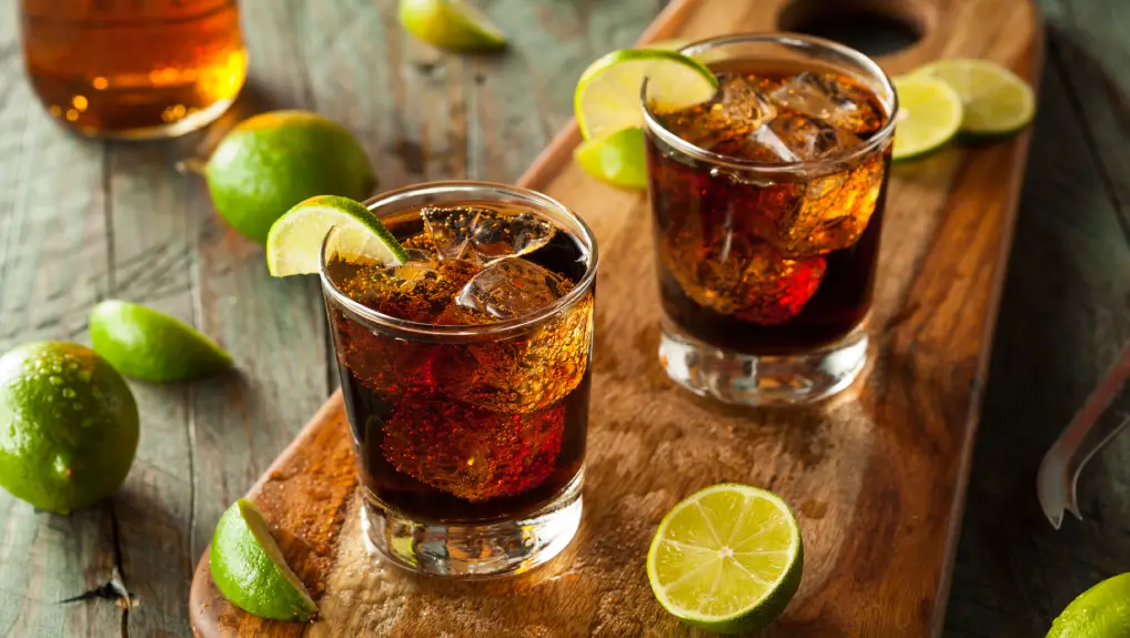 Image of Mixed drink using strong liquers and spirits with a lime garnish
