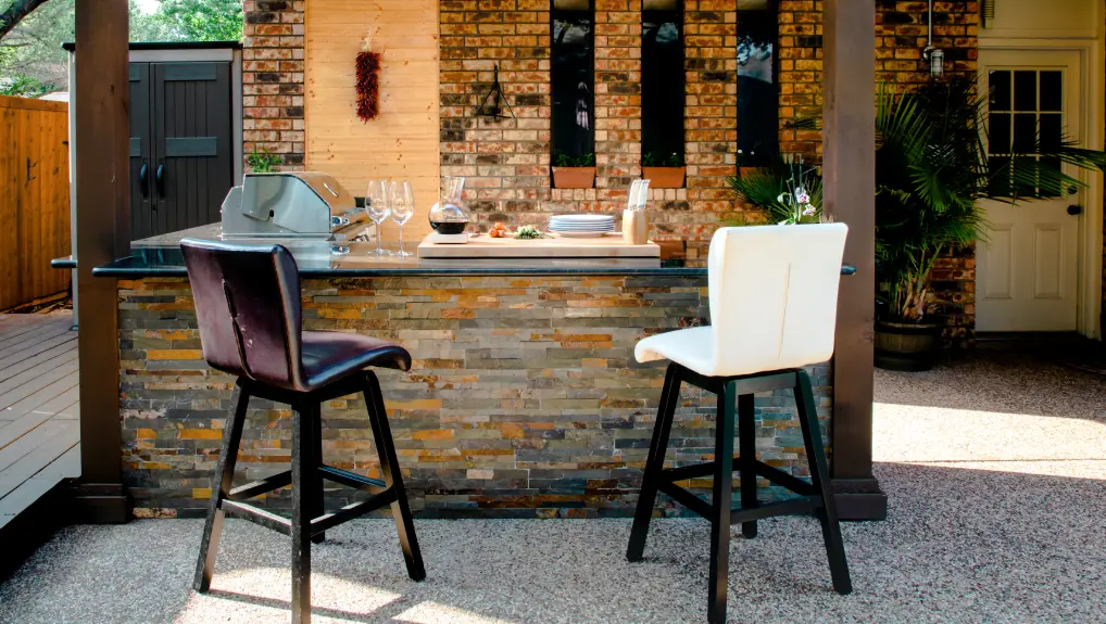 modern outdoor kitchen on a sunny summer evening- weatherproof bar accessories guide