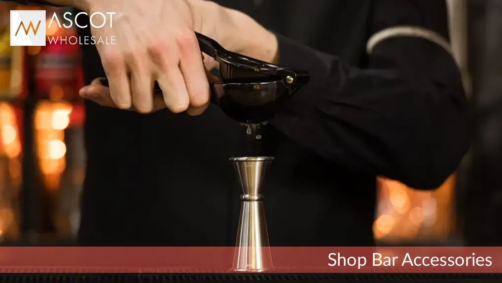 Image of bar accessories being used a jigger in an ambient lit bar.