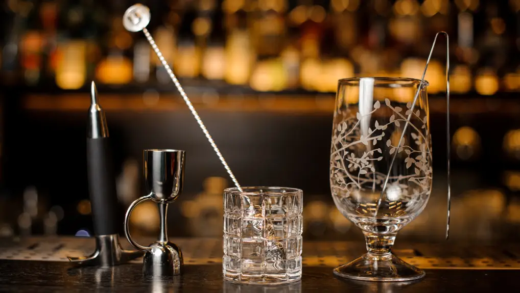 Set of barman equipment on the bar counter on the blurred background of the bar