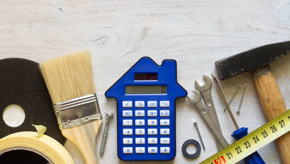 DIY tools and calculator on wooden white background, home renovation and construction concept, top view free space- catering equipment maintenance cost uk